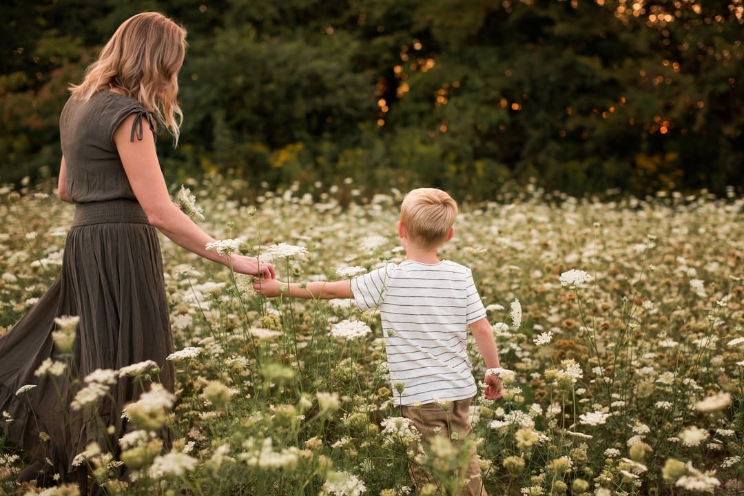 son giving flower to mother photo by Cynthia Dawson Photography 