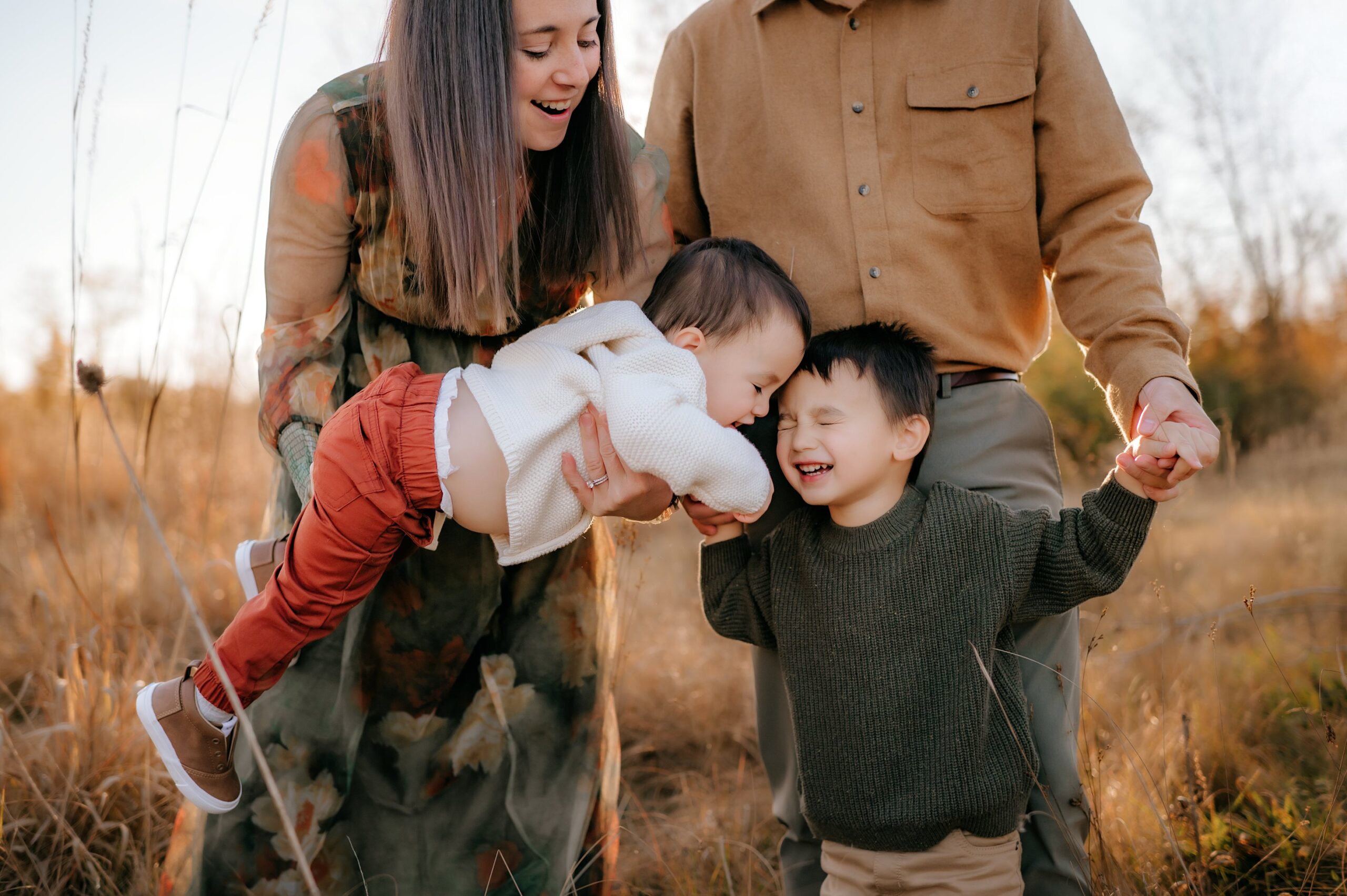 Fall Family Photographer Toledo Ohio little boy laughing as brother gives a hug