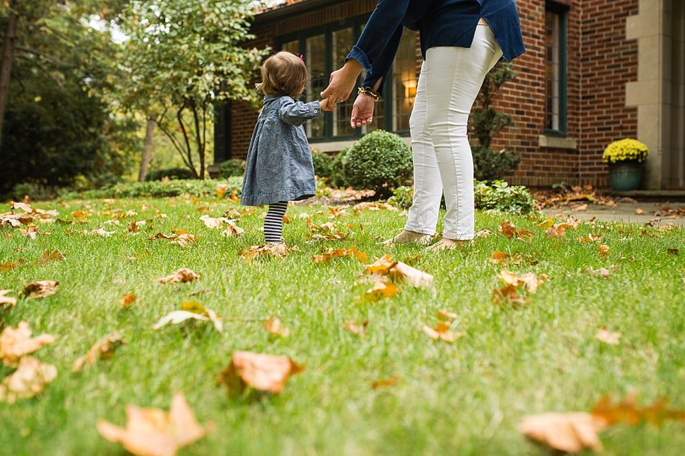 mother helping baby walk