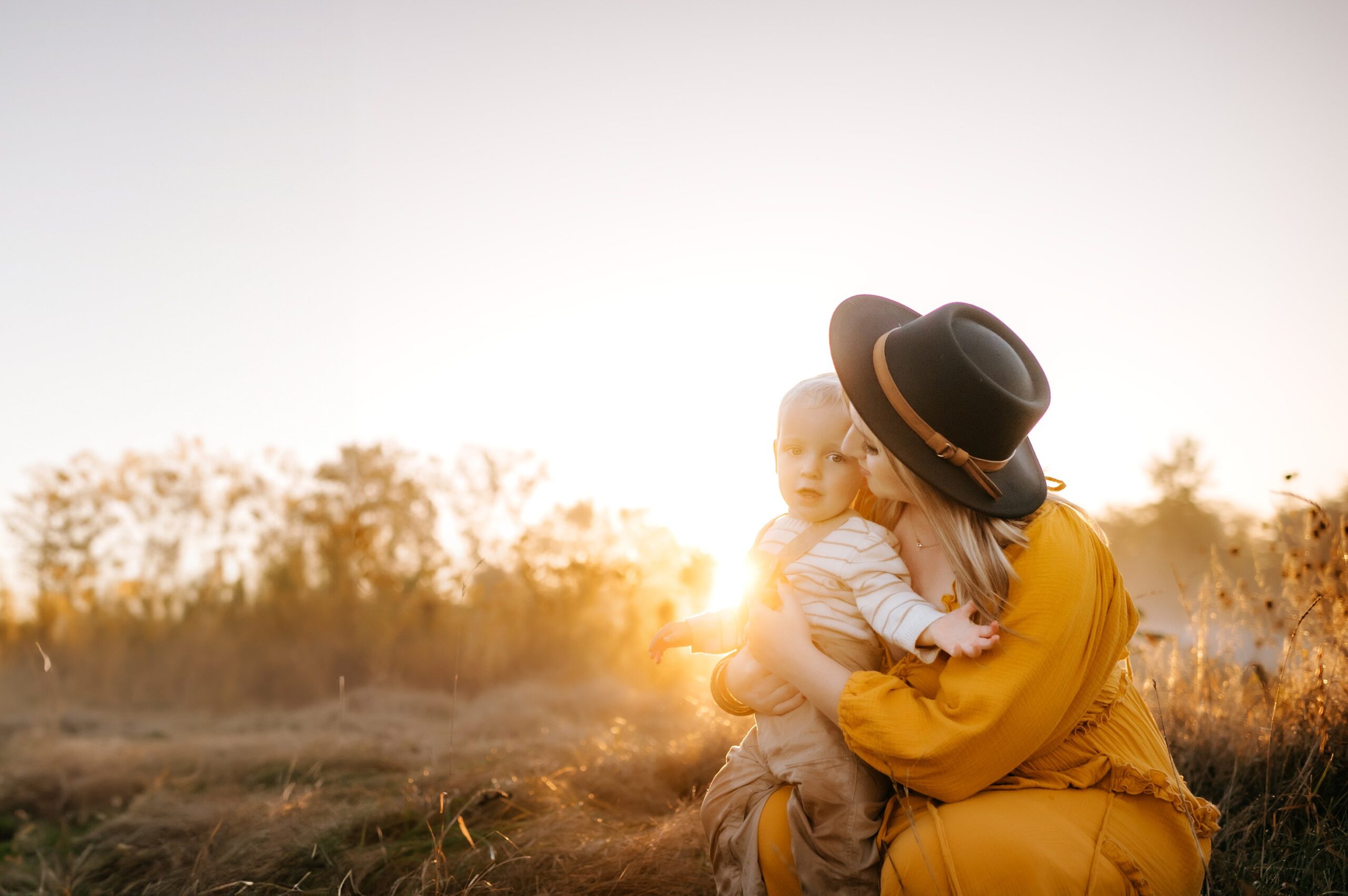 Findlay Ohio Photographer mother and toddler hugging in golden field photo by cynthia dawson photography