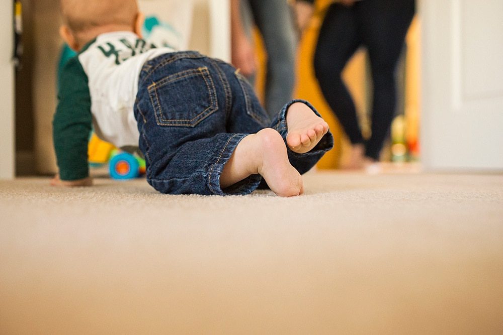 Toledo Ohio Baby Photography toddler playing while parents look on photo by cynthia dawson photography 