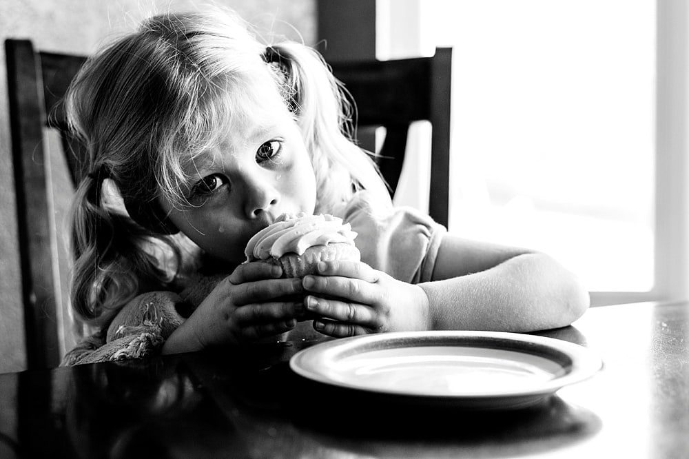 Event Photographer Toledo Ohio girl eating cupcake crying photo by Cynthia Dawson Photography 