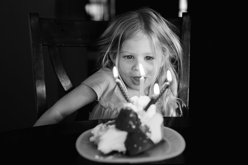 Event Photographer Toledo Ohio girl blowing out candles photo by Cynthia Dawson Photography 