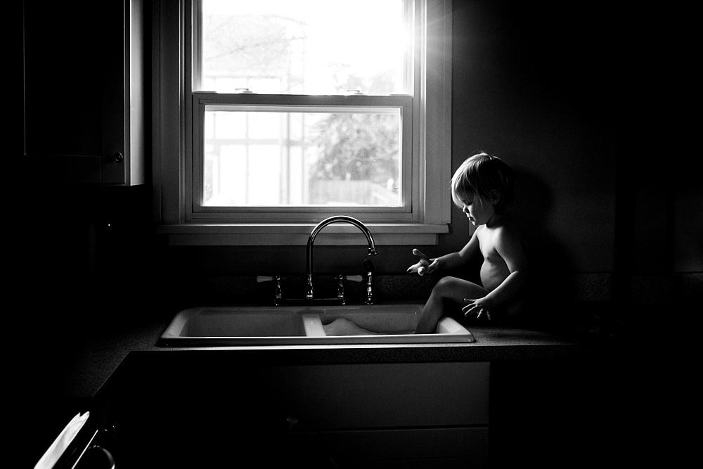 Lifestyle Photographer Toledo toddler playing with water in sink photo by Cynthia Dawson Photography 