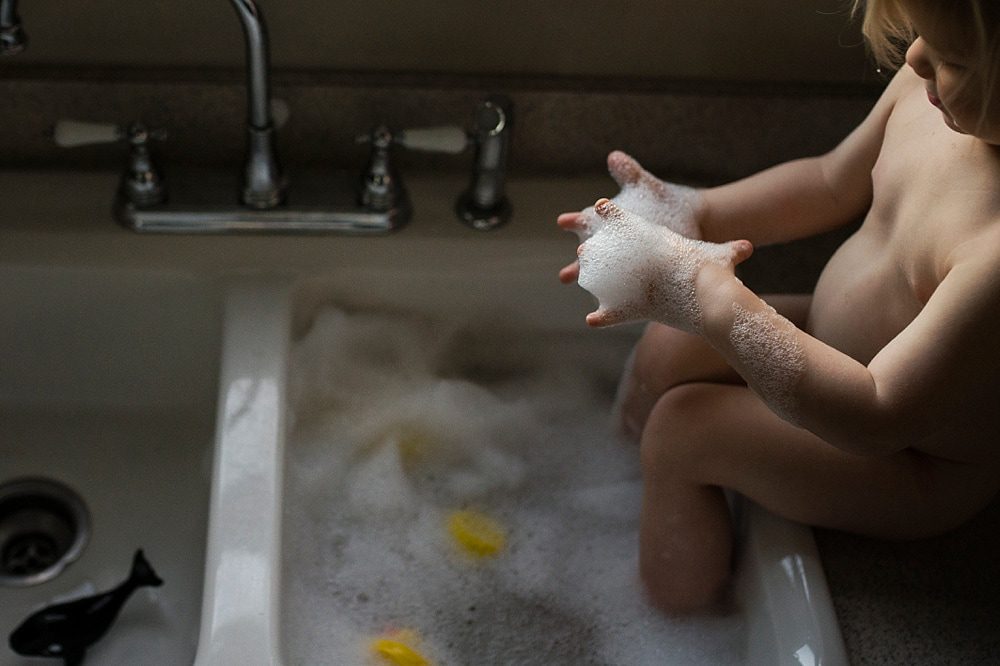 Lifestyle Photographer Toledo boy playing with bubbles in sink photo by Cynthia Dawson Photography