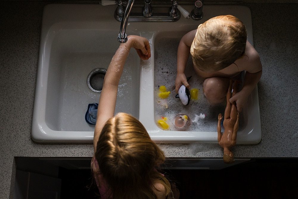 Lifestyle Photographer Toledo siblings in sink bath photo by Cynthia Dawson Photography