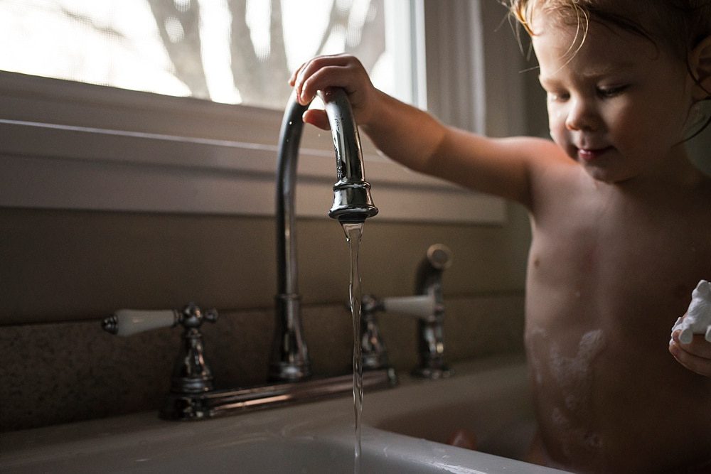 Lifestyle Photographer Toledo boy playing with water photo by Cynthia Dawson Photography