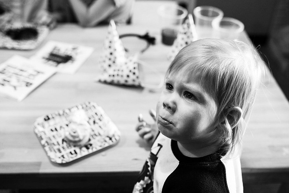 Birthday Party Places Toledo Ohio boy crying while eating cake photo by Cynthia Dawson Photography