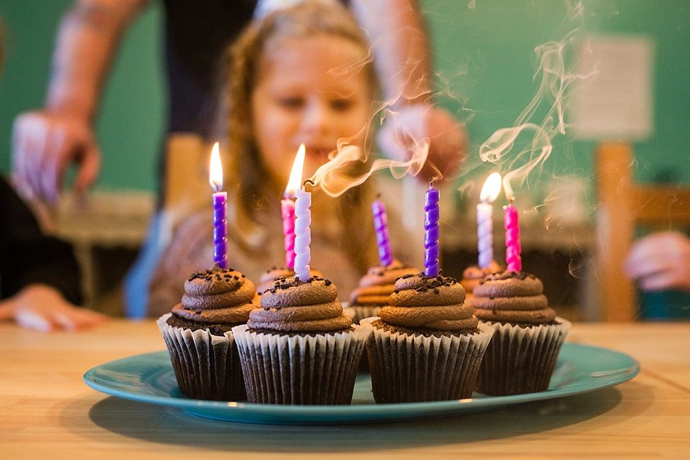 Event Photographer Toledo Ohio girl blowing out candles photo by Cynthia Dawson Photography 