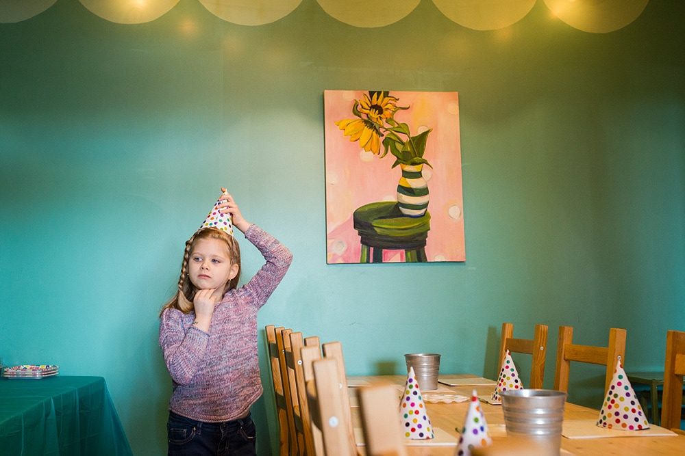 Birthday Party Places Toledo Ohio girl putting on party hat photo by Cynthia Dawson Photography