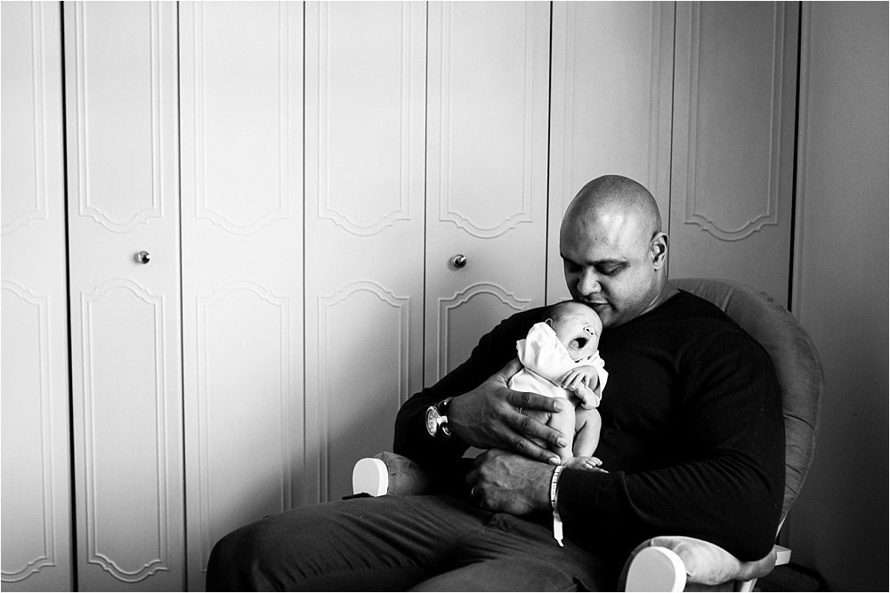 Toledo OH Newborn Photographer father holding new daughter yawning photo by Cynthia Dawson Photography