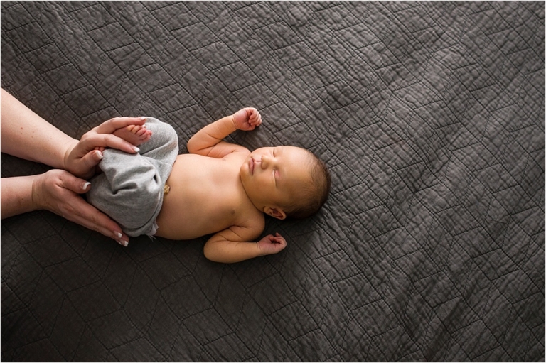 Toledo OH Newborn Photographer mother holding newborn's legs photo by Cynthia Dawson Photography