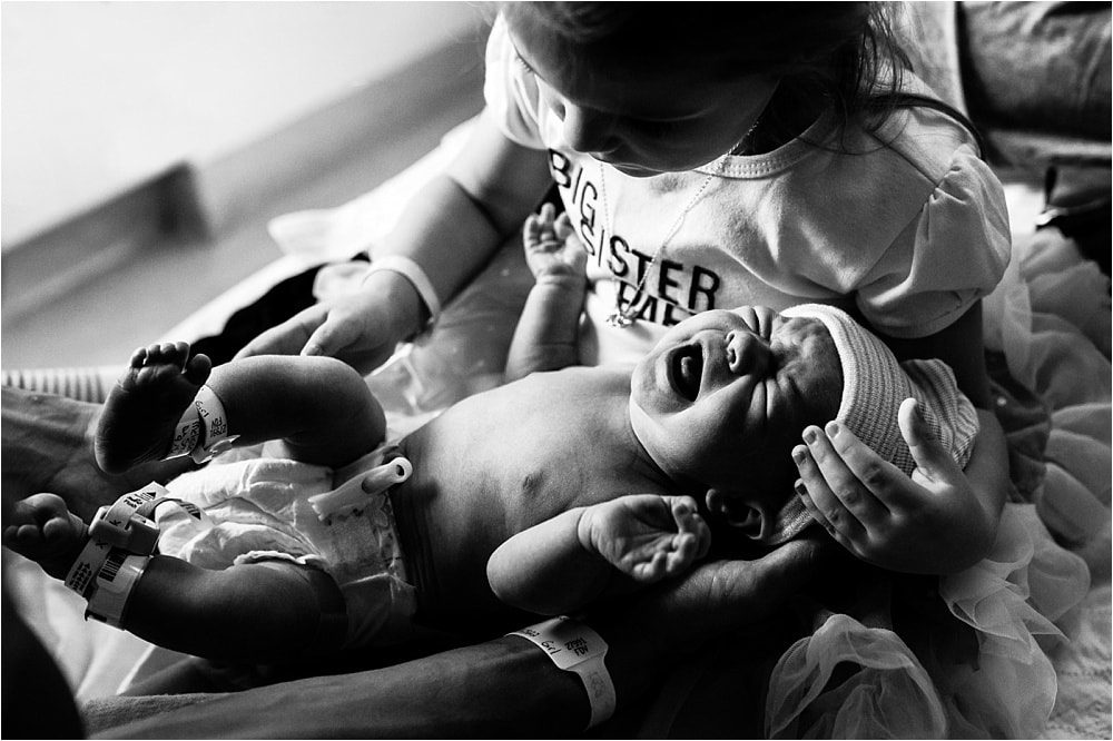 Labor and Delivery Toledo Hospital new sister holding baby photo by Cynthia Dawson Photography