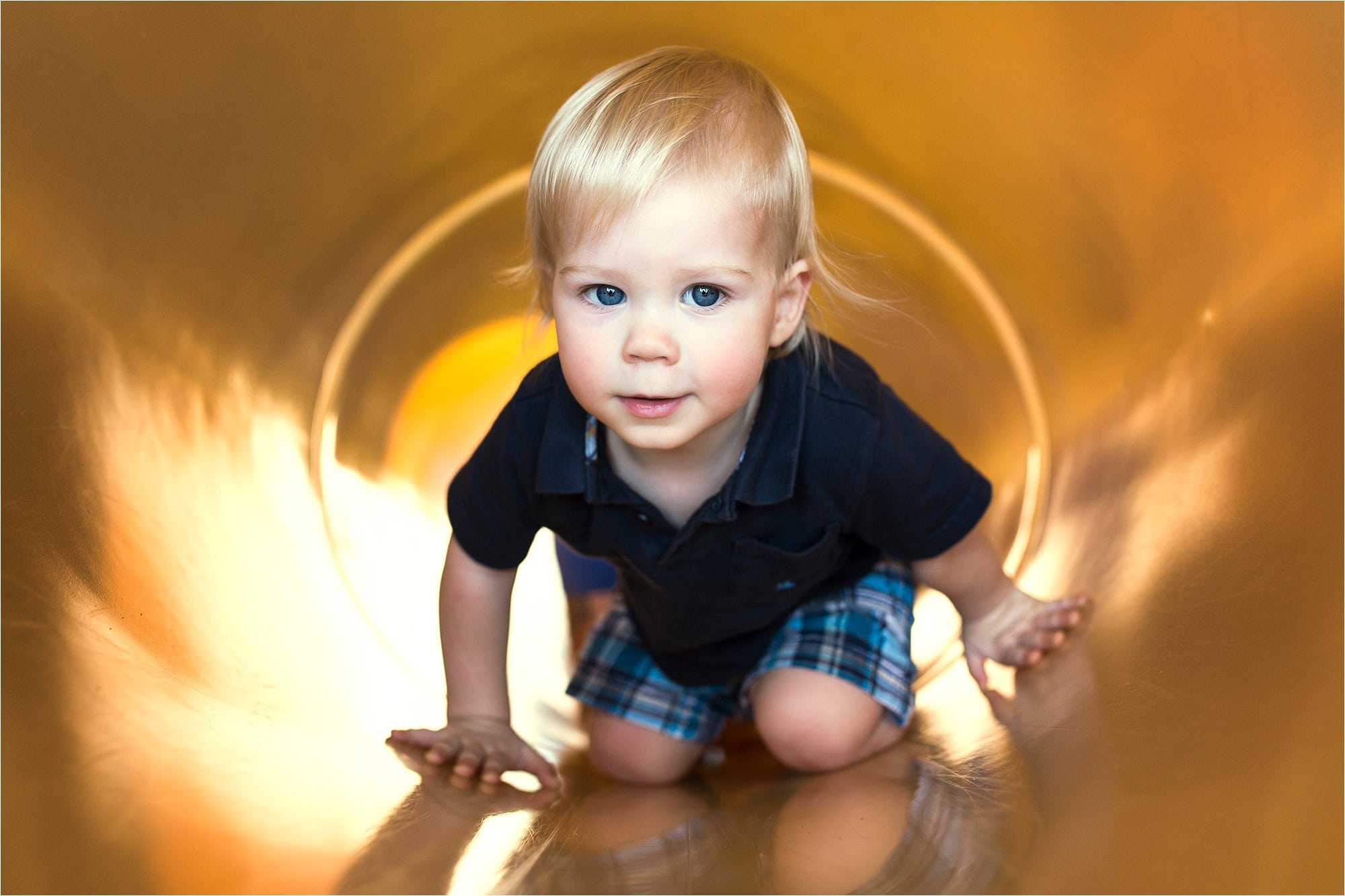 7 Ways to Use the Environment Around You to Frame Your Subject boy inside slide photo by Cynthia Dawson Photography 