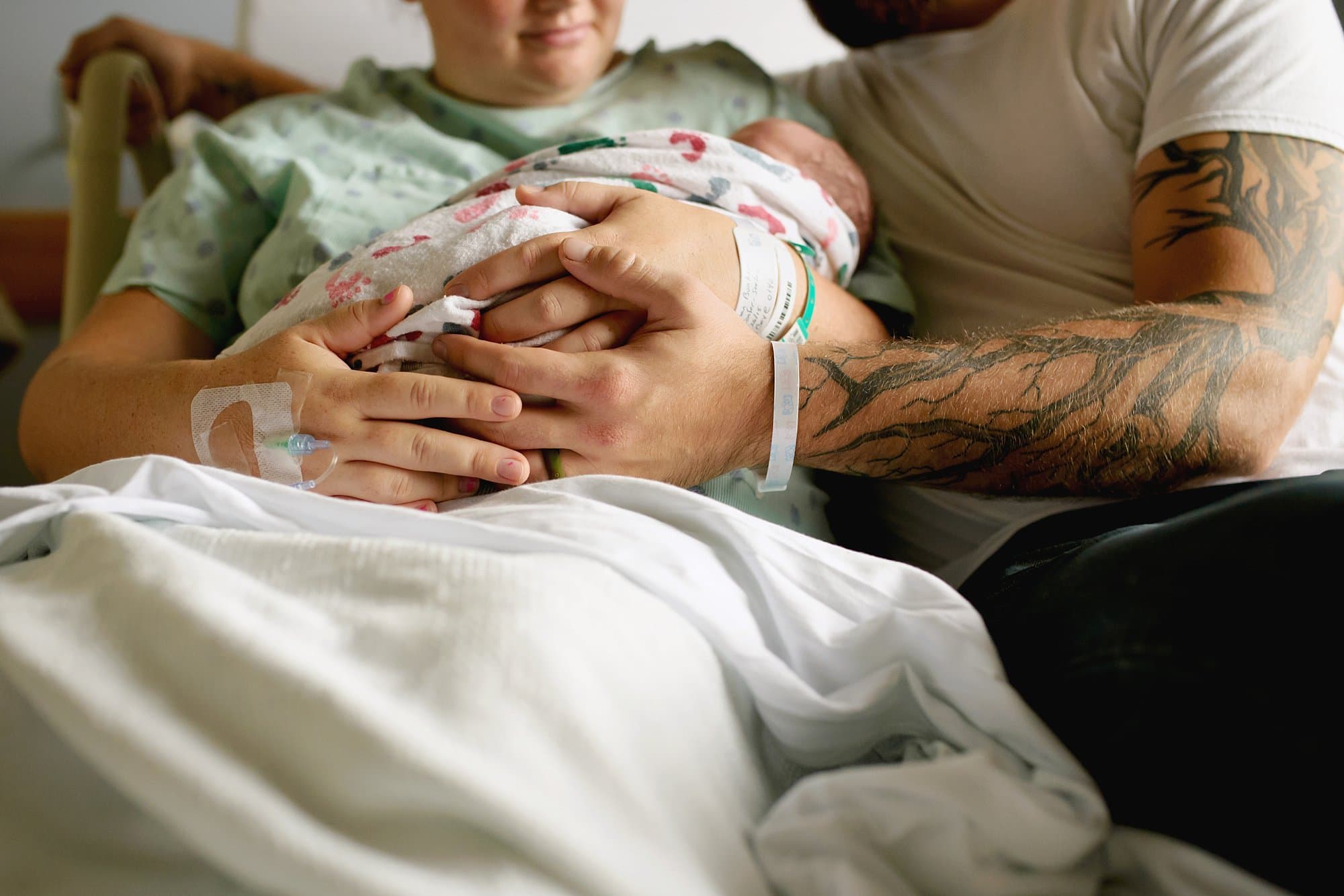 Toledo Newborn Photographers couple holding newborn photo by Cynthia Dawson Photography