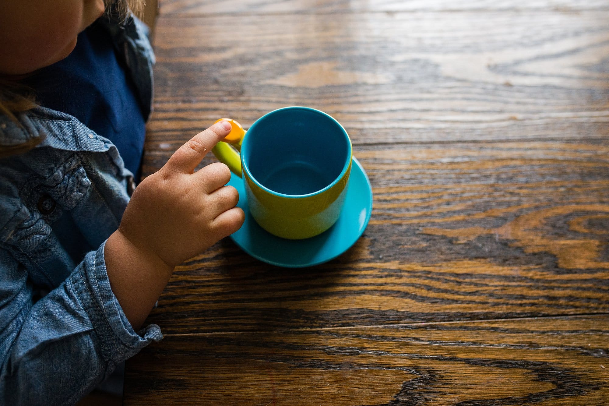 Toledo Family Photographer Review child holding cup photo by Cynthia Dawson Photography