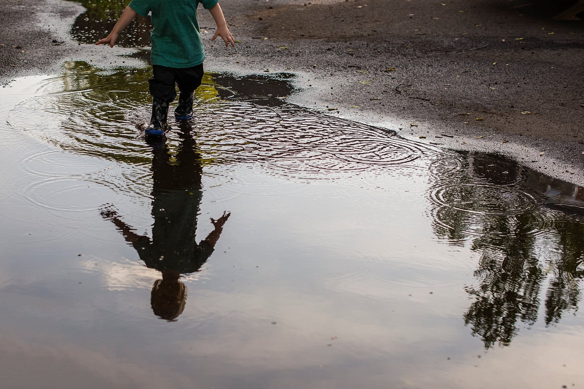 Lifestyle Photography Northwest Ohio boy standing in puddle photo by Cynthia Dawson Photography