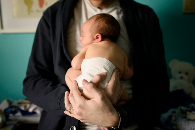 Northwest Ohio Newborn Lifestyle Photographer dad holding baby photo by Cynthia Dawson Photography