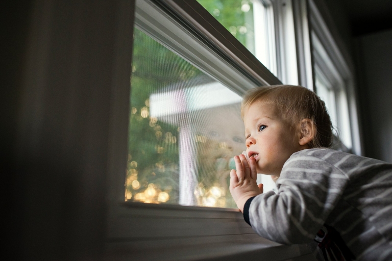 Photographers Toledo Ohio toddler looking out window photo by Cynthia Dawson Photography 