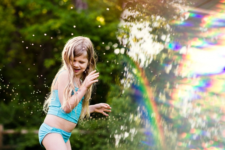 Family Fun in Toledo Ohio girl in sprinkler photo by Cynthia Dawson Photography