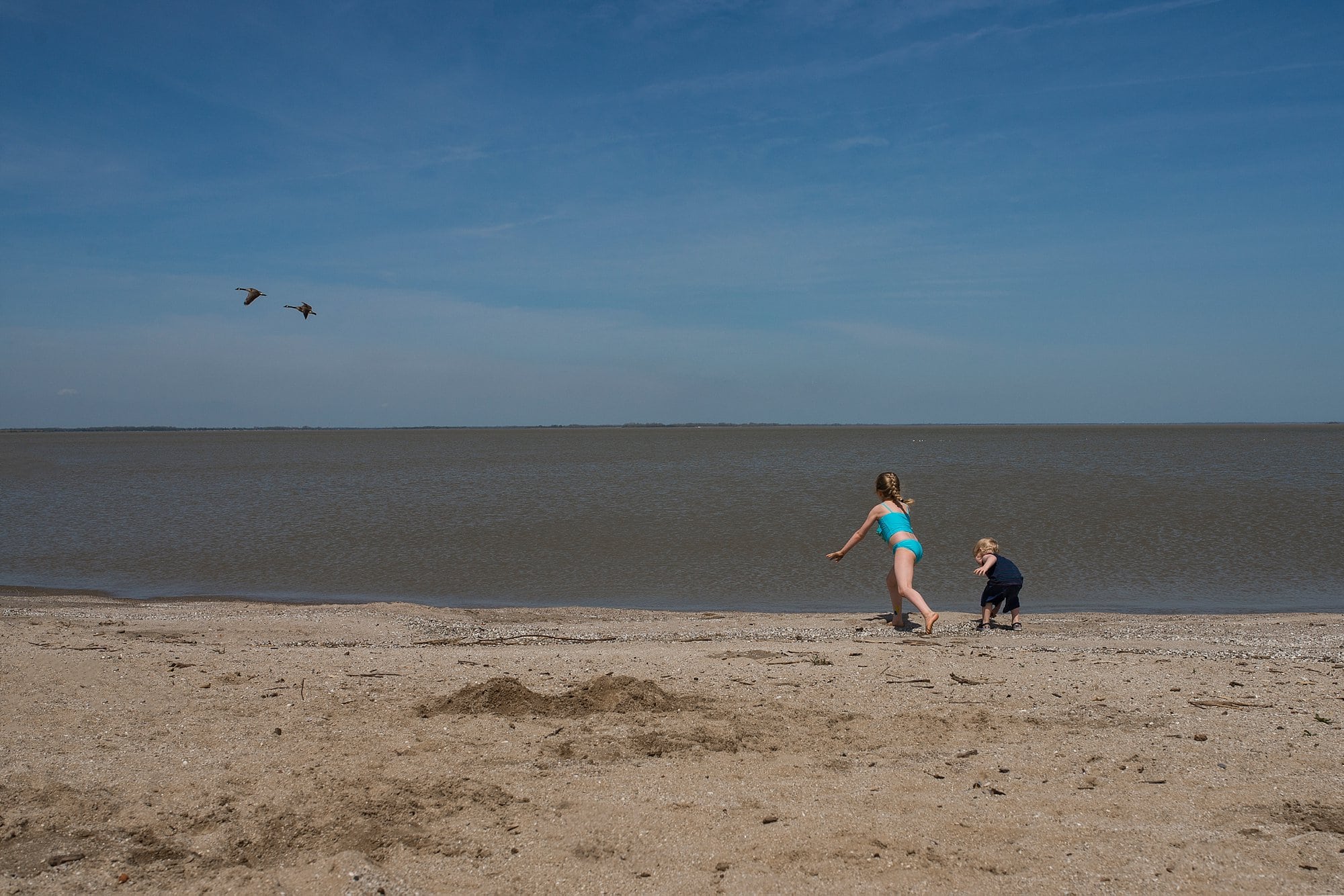 Maumee Bay Beach two kids playing on beach photo by Cynthia Dawson photography