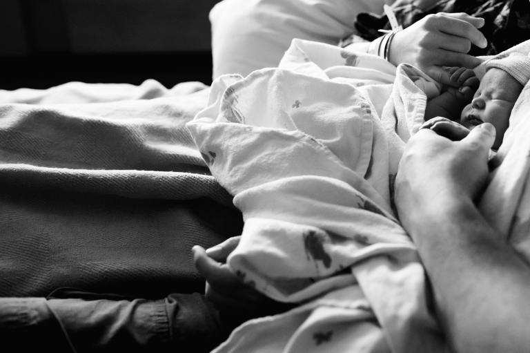 Toledo Newborn Photographers couple holding newborn hands photo by Cynthia Dawson Photography