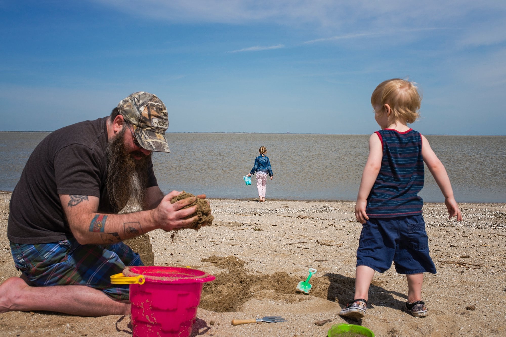 Family Photographer in Toledo Ohio family playing in sand photo by Cynthia Dawson Photography