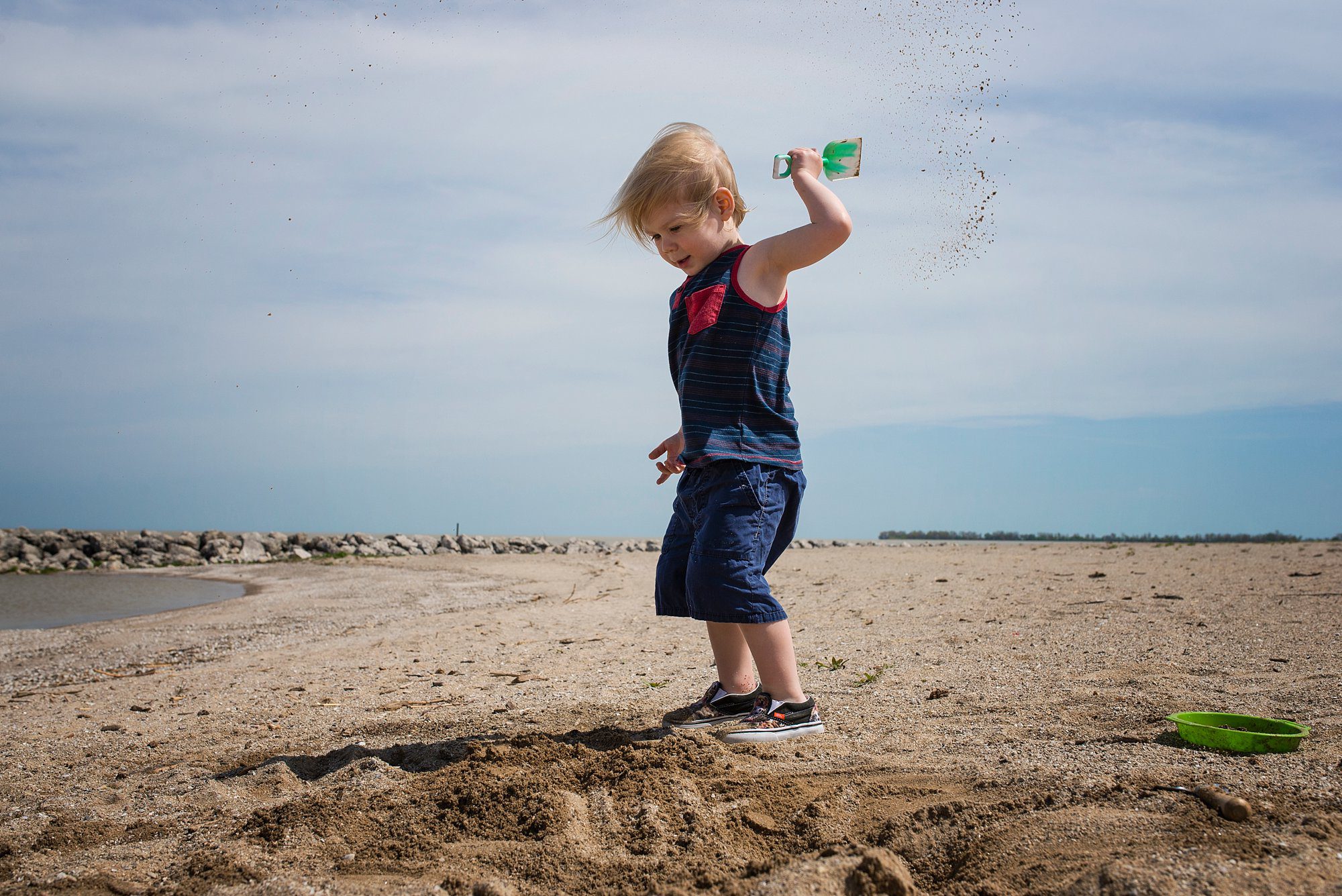 Family Photographer in Toledo Ohio toddler throwing sand photo by Cynthia Dawson Photography