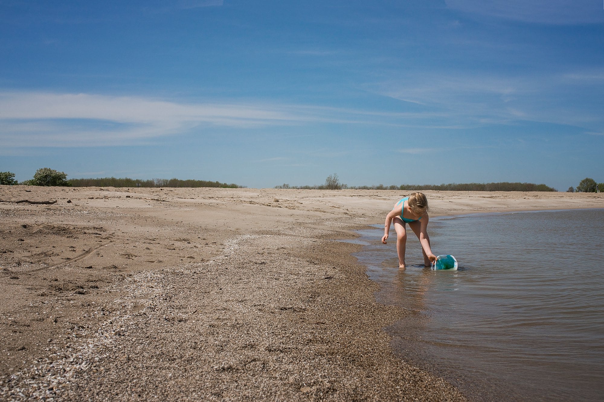 Family Photographer in Toledo Ohio girl on beach shore photo by Cynthia Dawson Photography