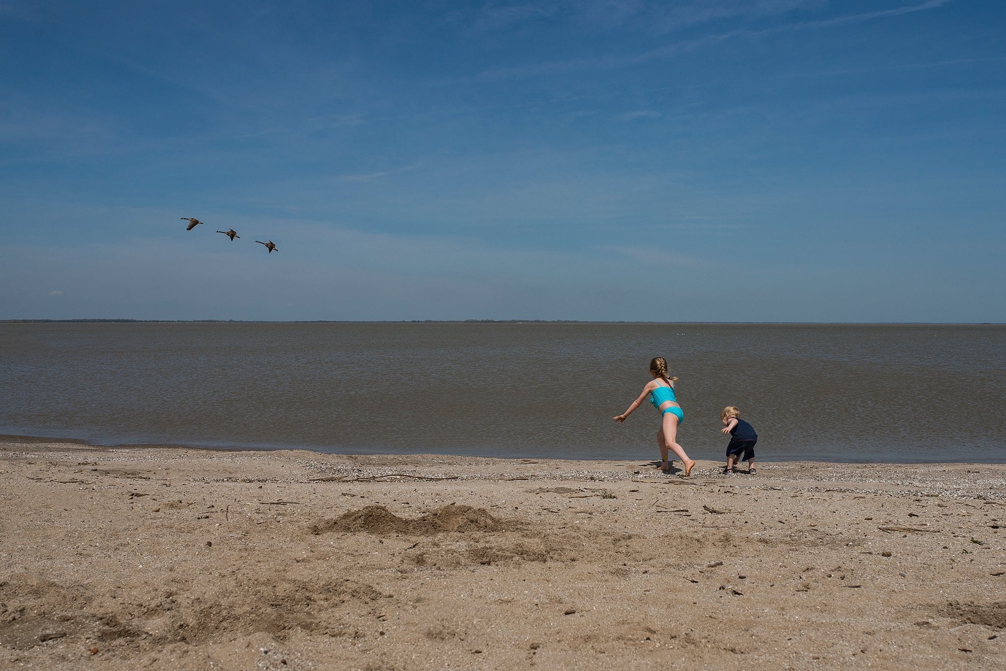 Family Photographer in Toledo Ohio two kids on beach shore photo by Cynthia Dawson Photography