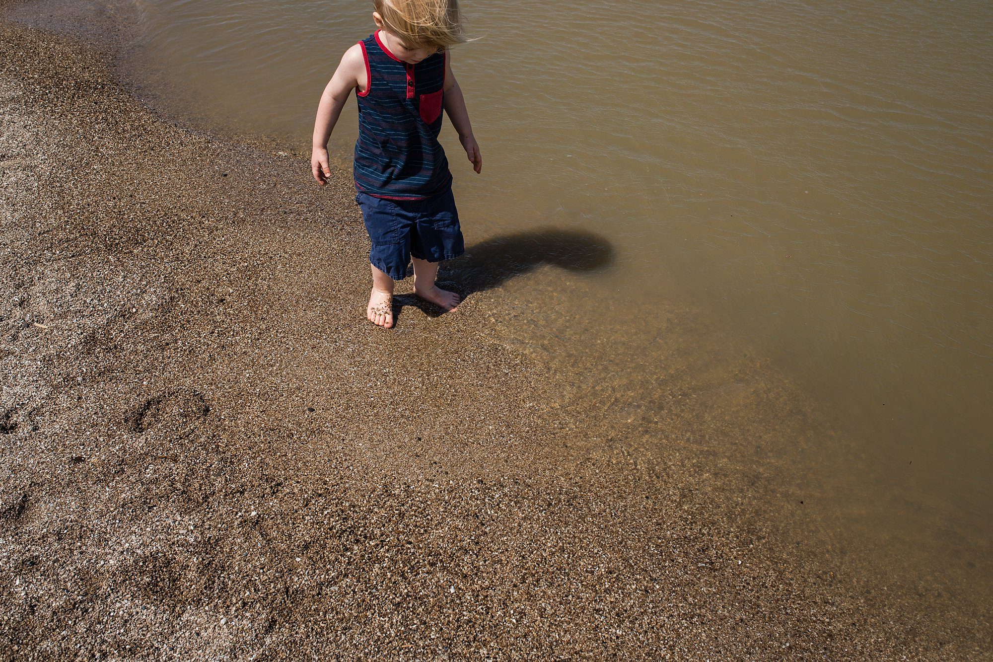 Family Photographer in Toledo Ohio two boy getting feet wet photo by Cynthia Dawson Photography