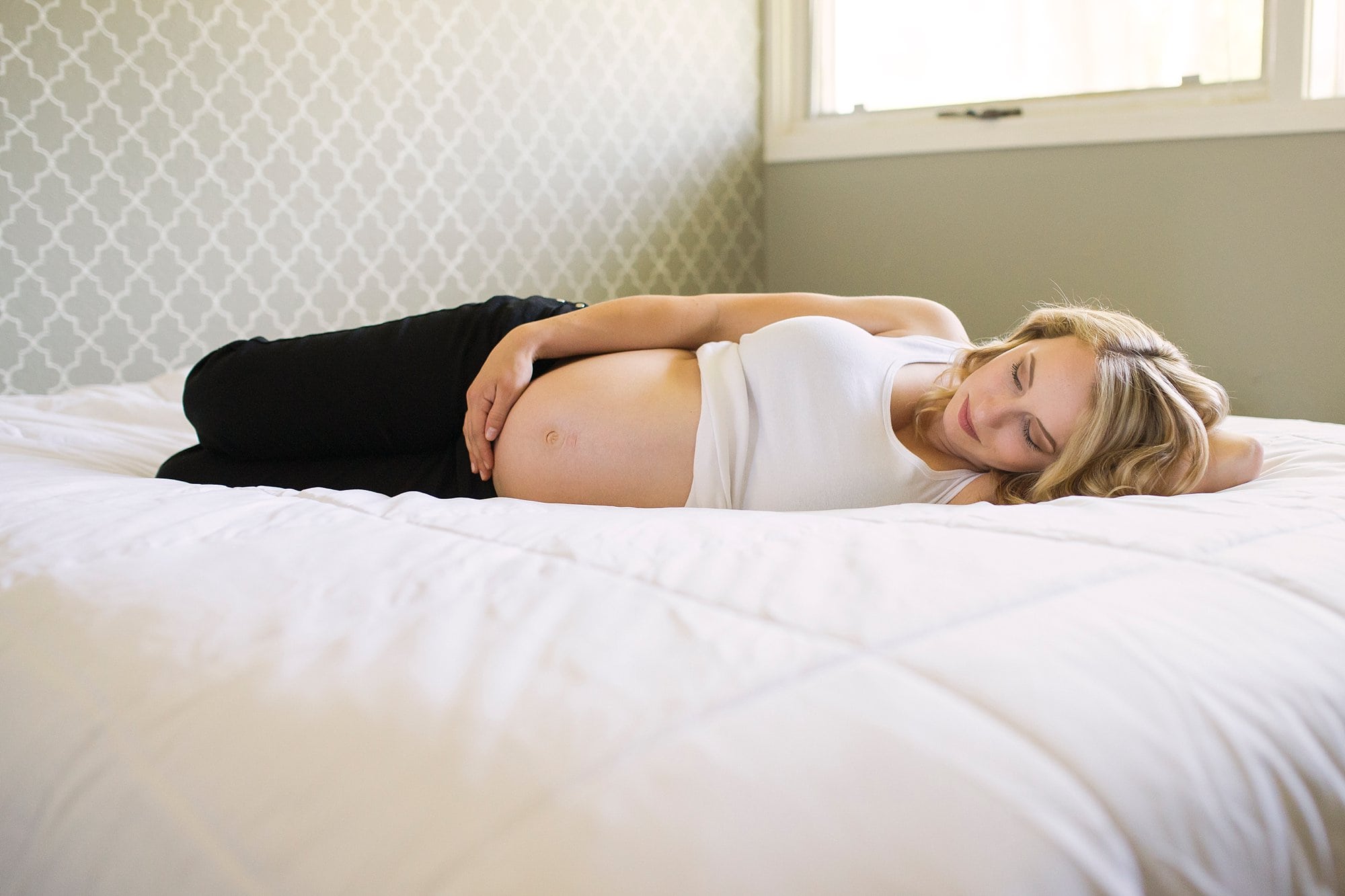 Lifestyle Maternity Photographer mom holding her belly photo by Cynthia Dawson Photography