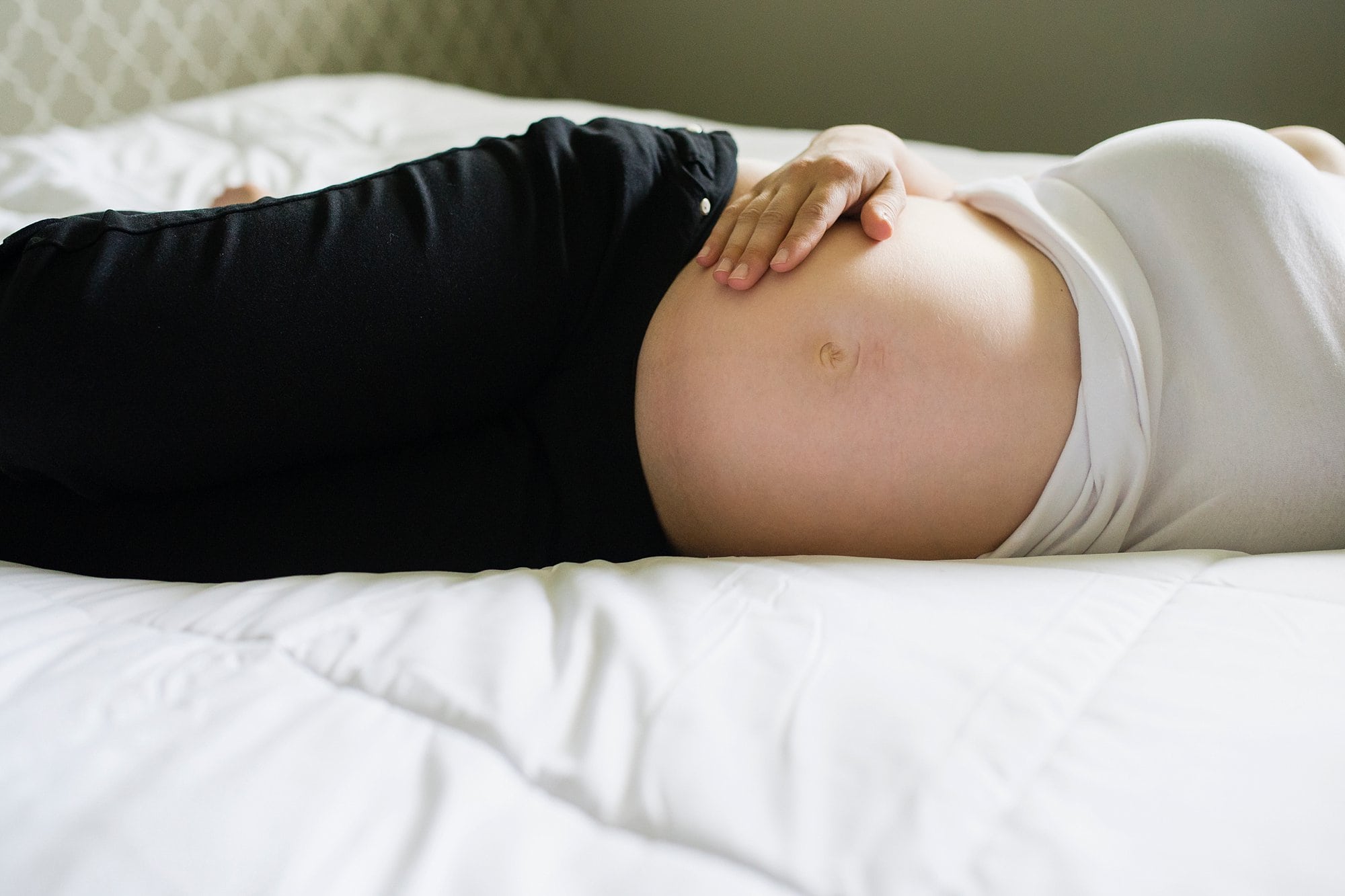 Lifestyle Maternity Photographer pregnant woman holding pregnant belly photo by Cynthia Dawson Photography