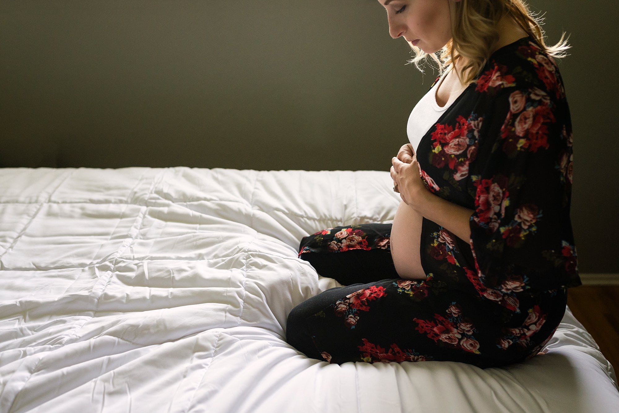 Lifestyle Maternity Photographer pregnant woman looking at belly photo by Cynthia Dawson Photography