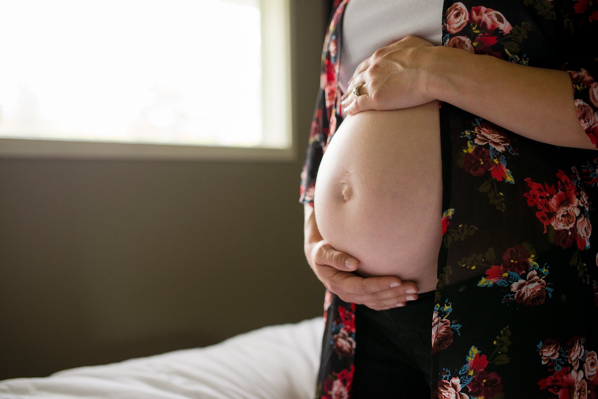 Lifestyle Maternity Photographer close up of pregnant belly photo by Cynthia Dawson Photography