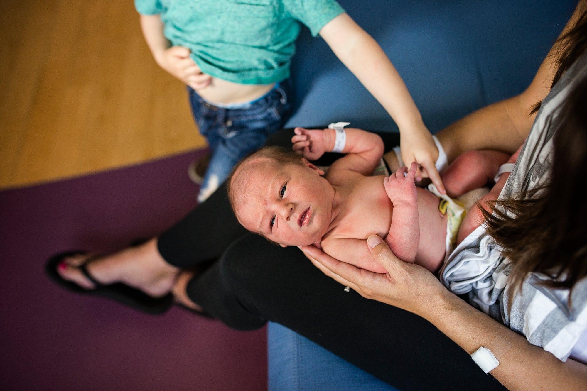 Toledo Newborn Photographer brother touching baby's belly photo by Cynthia Dawson Photography