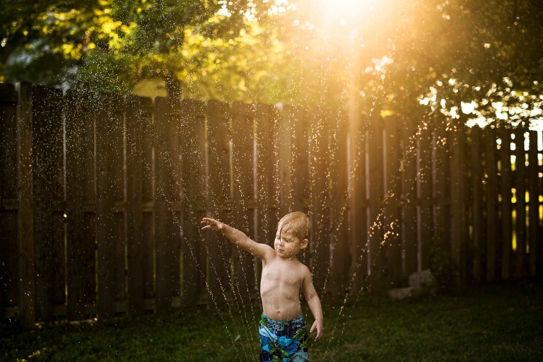 Toledo Ohio Summer Photo Session toddler in sprinkler photo by Cynthia Dawson Photography