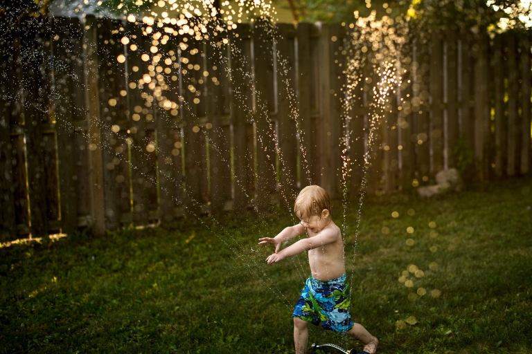Toledo Ohio Summer Photo Session boy running through sprinkler photo by Cynthia Dawson Photography