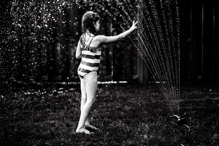 Toledo Ohio Summer Photo Session girl playing sprinkler photo by Cynthia Dawson Photography