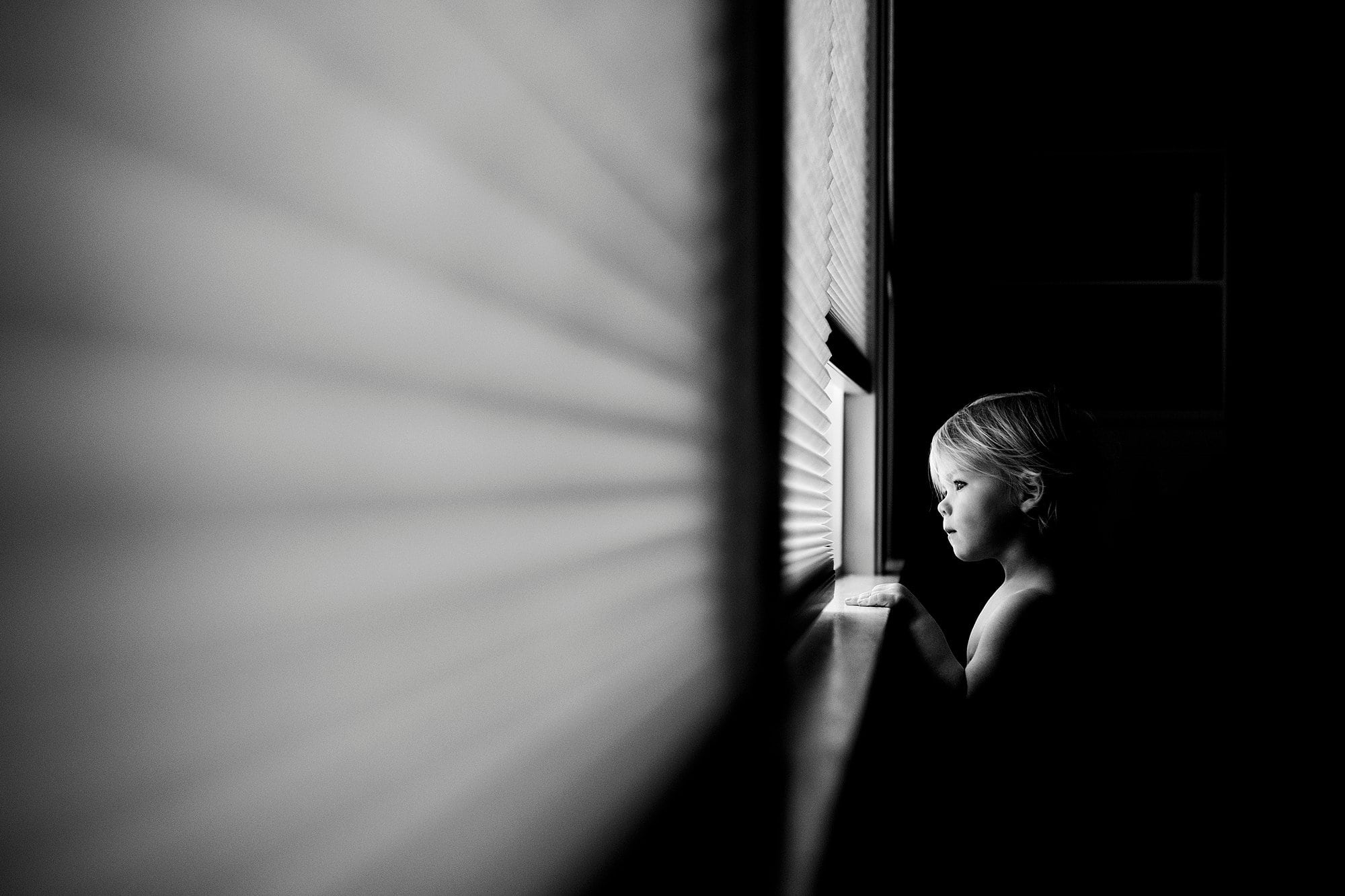 Family Photographer Northwest Ohio boy looking out window photo by Cynthia Dawson Photography