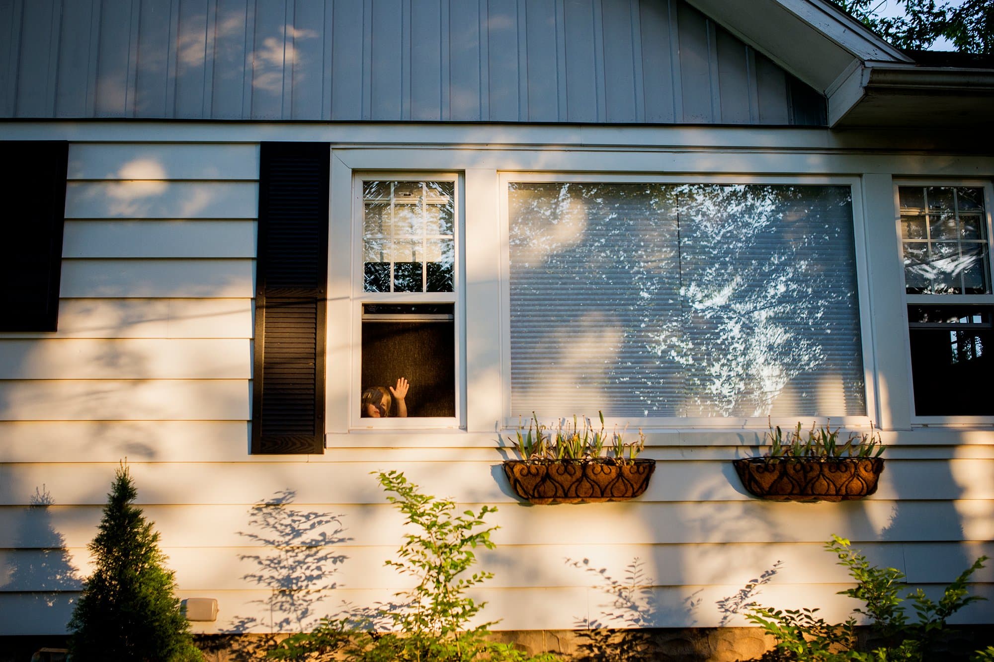 Family Photographer Northwest Ohio boy looking out window photo by Cynthia Dawson Photography