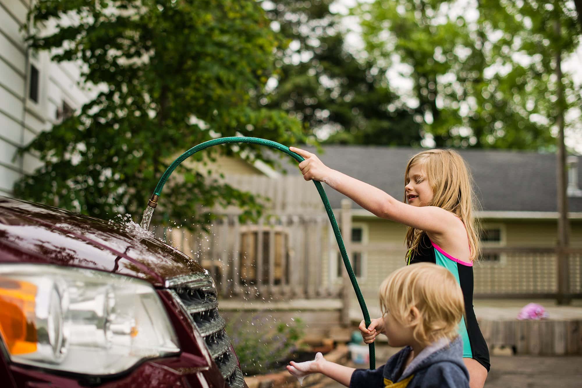 Family Photographer Northwest Ohio kids washing a car photo by Cynthia Dawson Photography