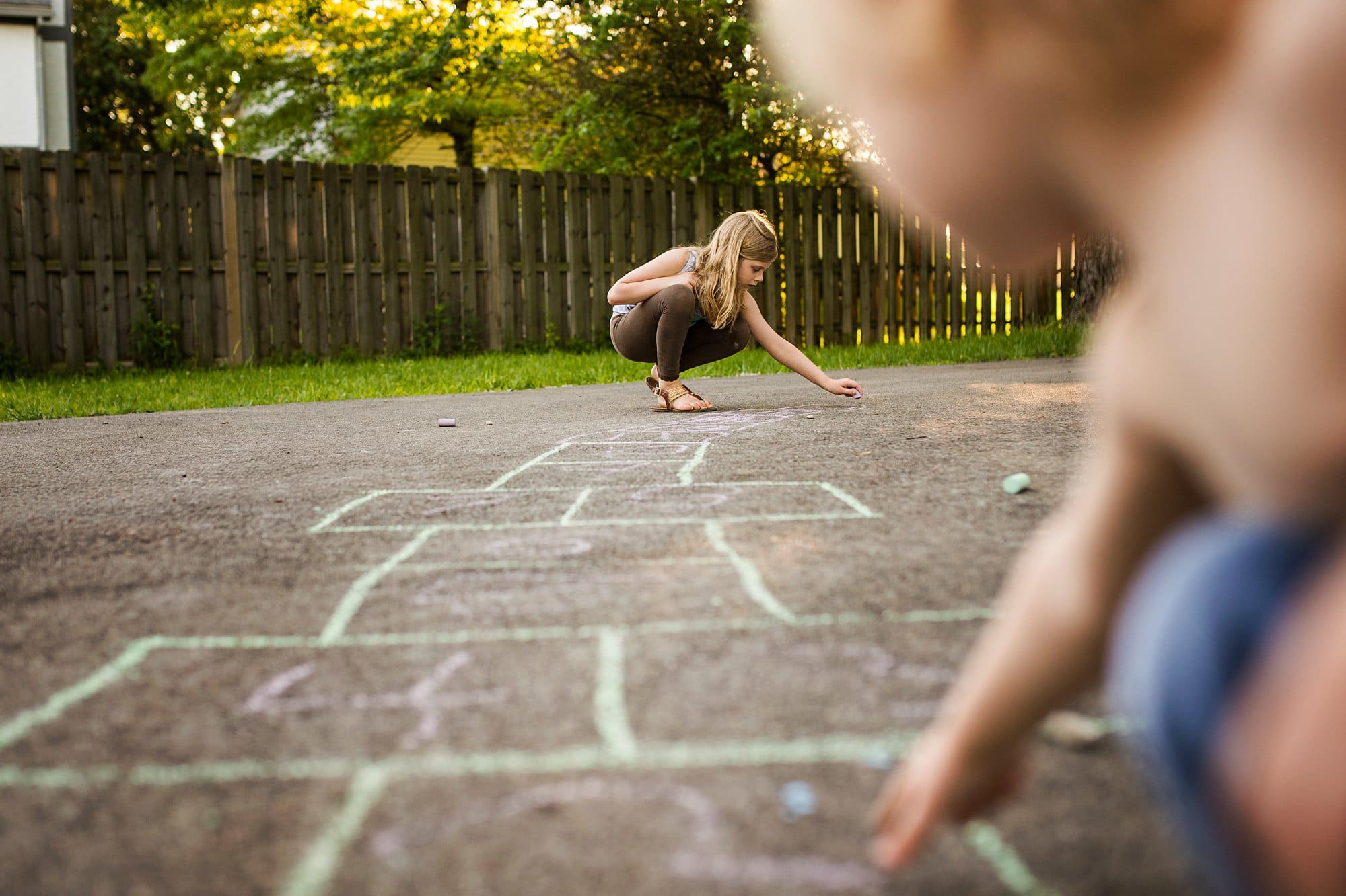 Family Photographer Northwest Ohio kids playing hopscotch photo by Cynthia Dawson Photography