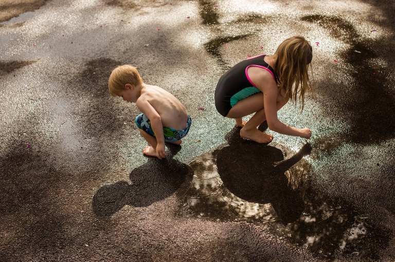 Northwest Ohio Lifestyle Photographer siblings playing in puddle photo by Cynthia Dawson Photography