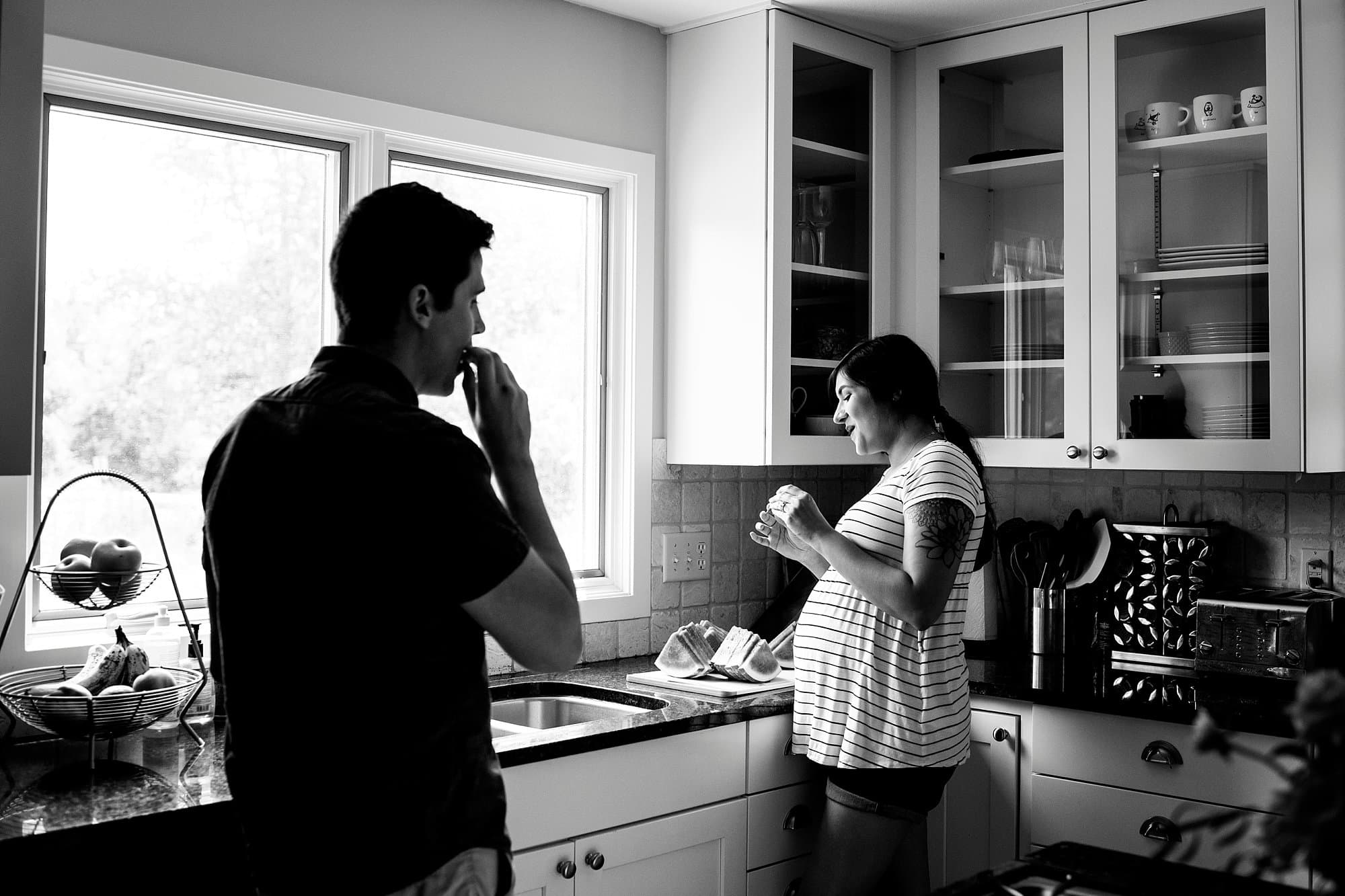 Toledo Lifestyle Maternity Photographer pregnant woman cutting watermelon photo by Cynthia Dawson Photography