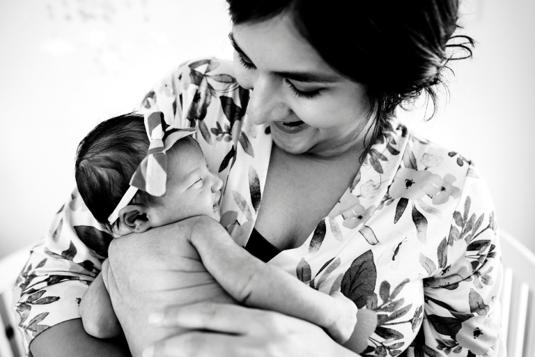 Newborn Lifestyle Photography Toledo Ohio mother smiling holding newborn girl photo by Cynthia Dawson Photography