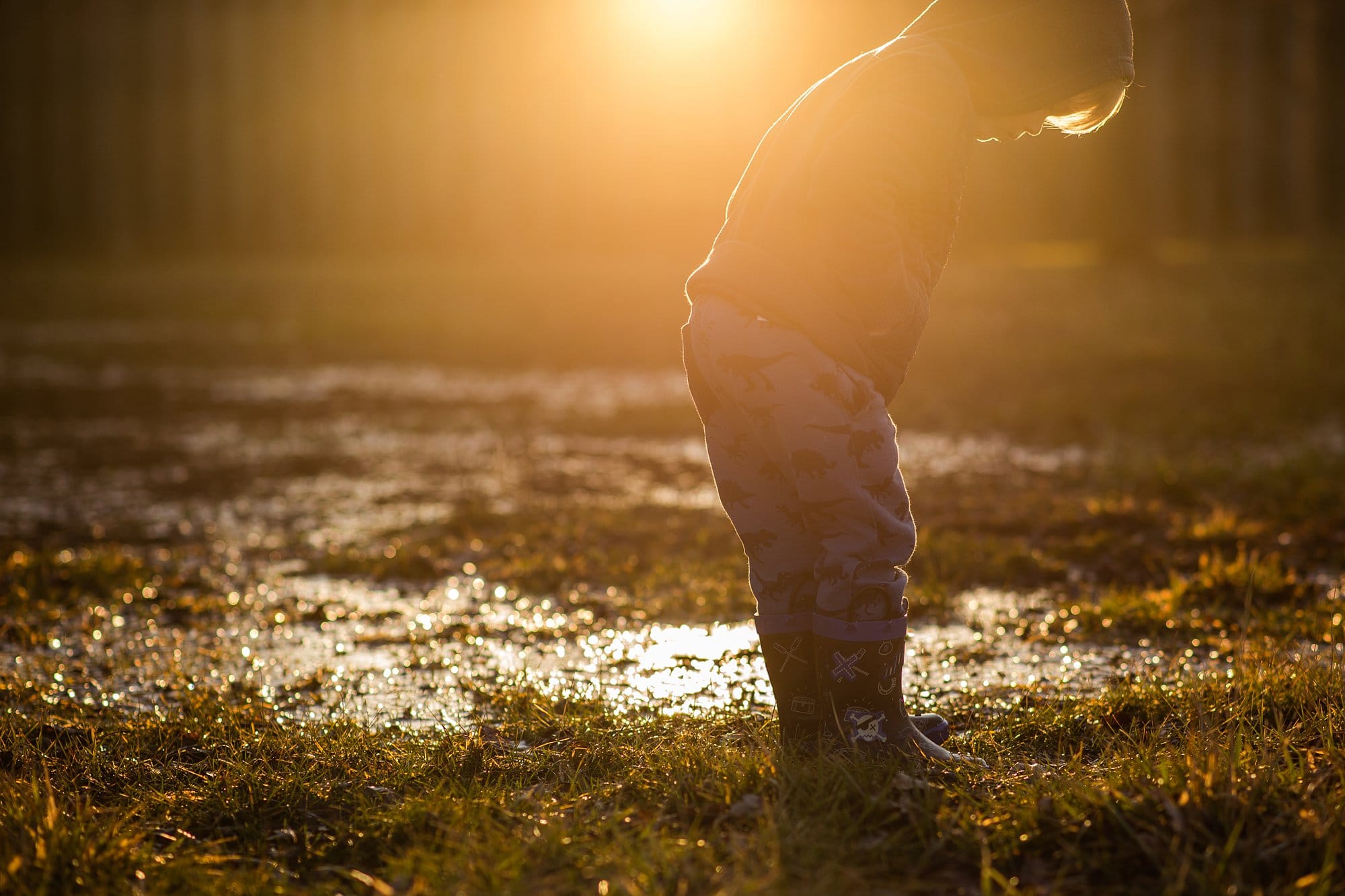 Toledo Child Photographer boy in puddle outside photo by Cynthia Dawson Photography