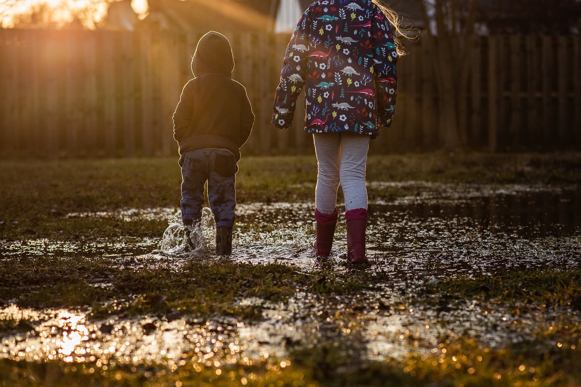 Toledo Child Photographer kids waling through puddle photo by Cynthia Dawson Photography