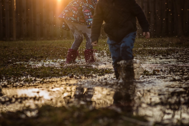 Toledo Child Photographer kids splashing through puddle photo by Cynthia Dawson Photography