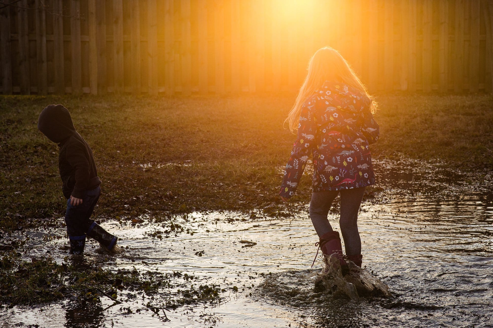 Toledo Child Photographer kids in puddle outside photo by Cynthia Dawson Photography